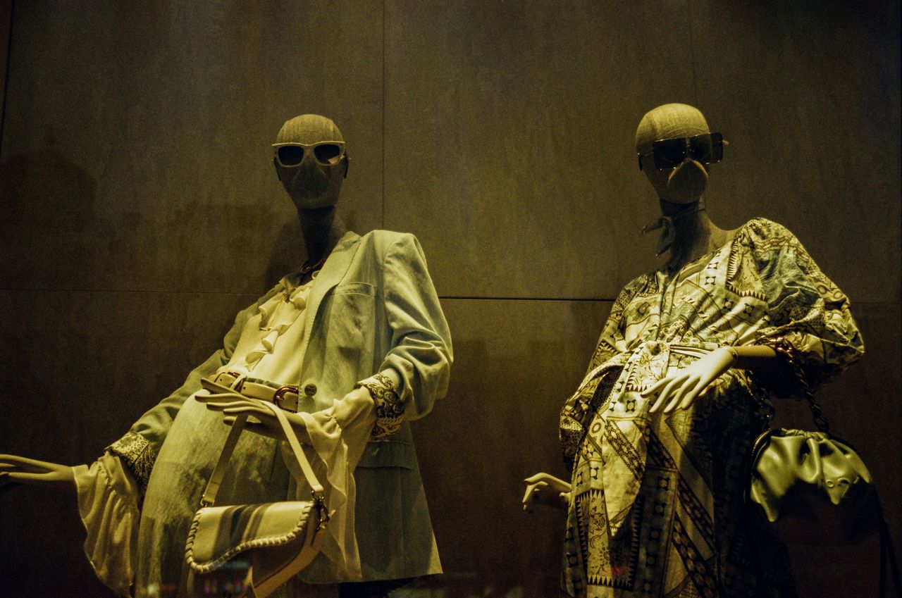 about-01 Chic window display featuring mannequins in stylish outfits, offering a sense of luxury fashion.